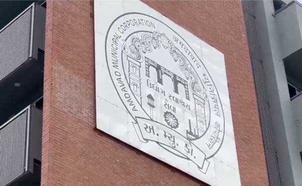 The Amdavad Municipal Corporation emblem on an AMC office building