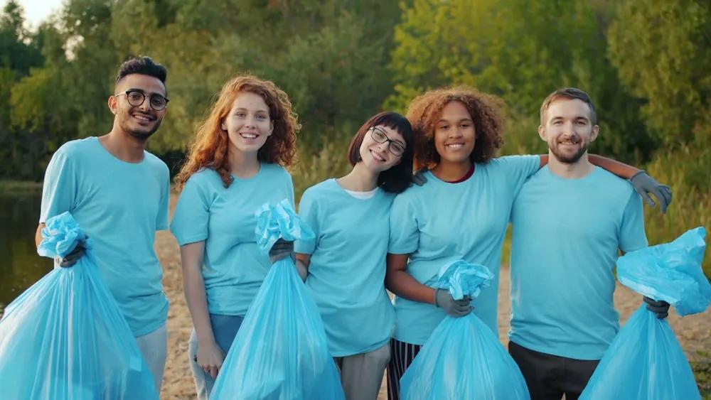 Team of volunteers holding bags outdoors